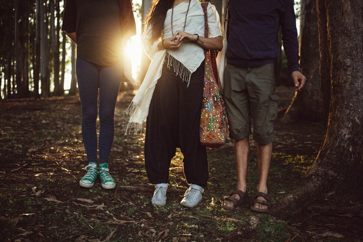 Three friends pause in Munnar forest light near Top Station, Kerala. print option
