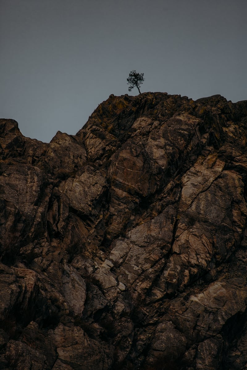 Dark Osoyoos rock and sky in a warm desert-edge study. print option
