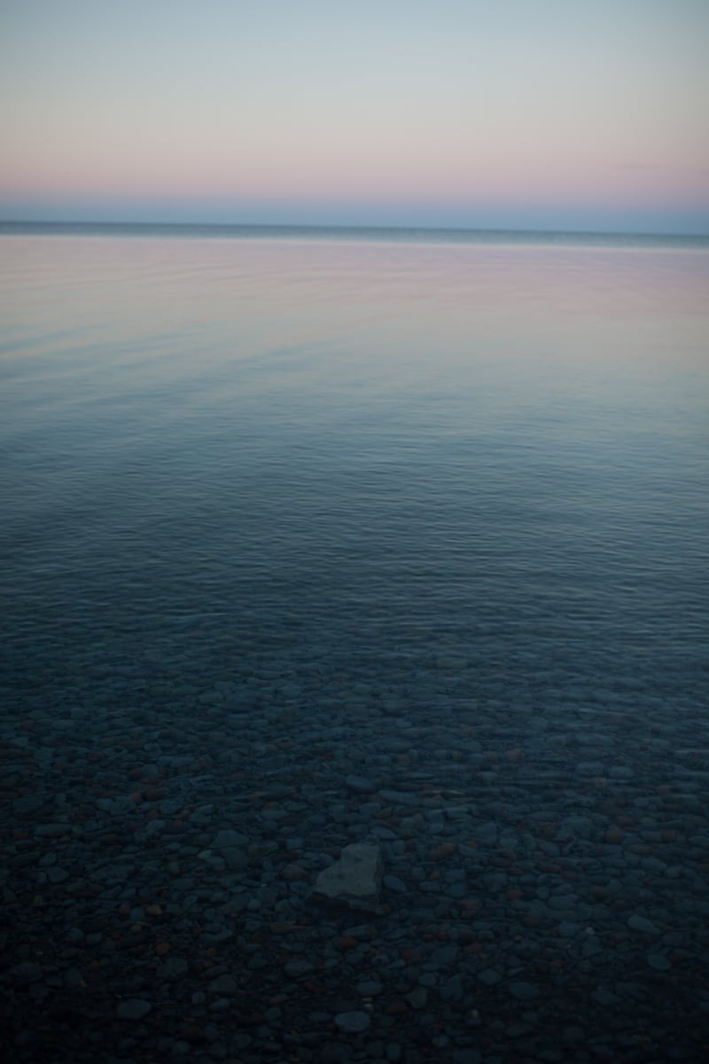 Calm Lake Huron water fades from blue into a pale horizon. print option