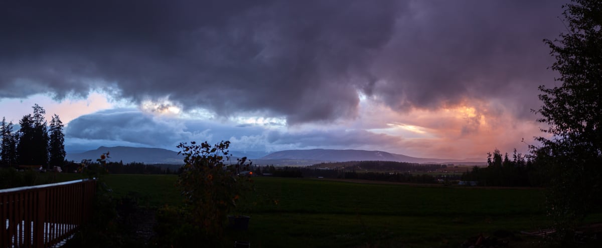A wide storm-lit field and valley view near Armstrong and Spallumcheen. print option