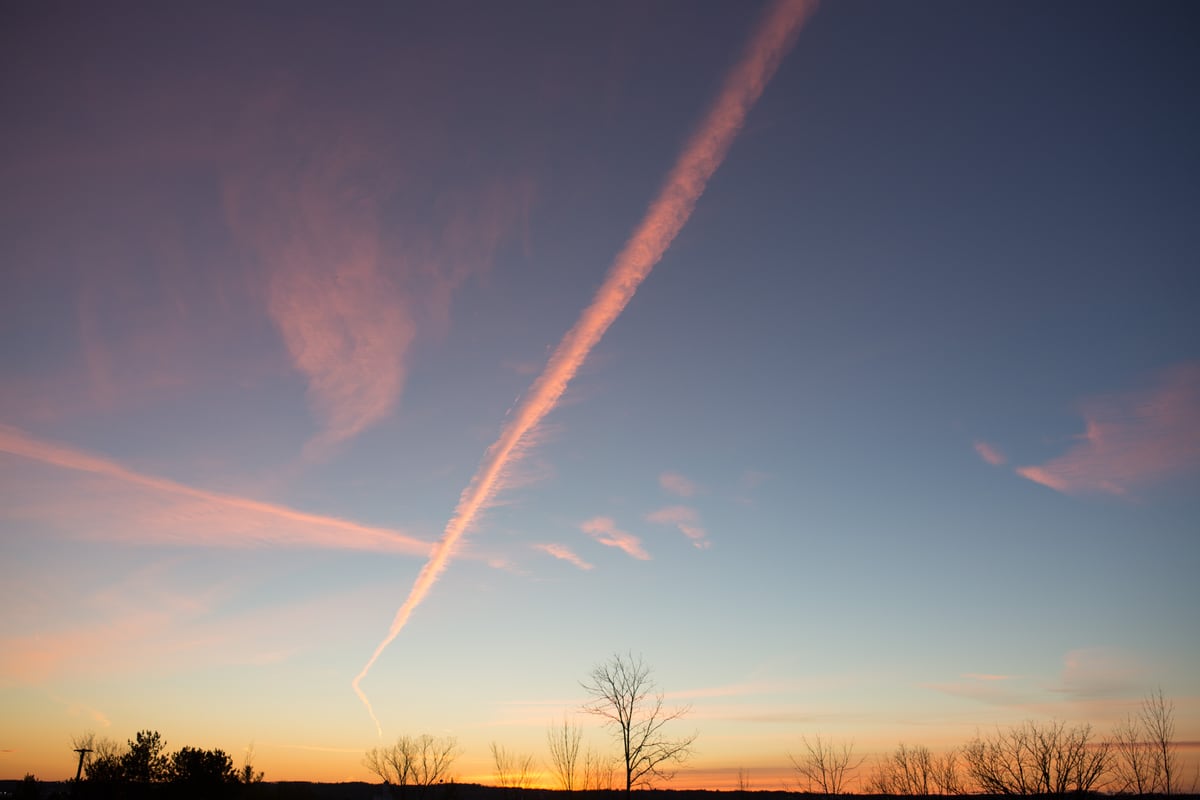Pink contrails and blue evening sky stretch above a low Peterborough winter horizon. print option