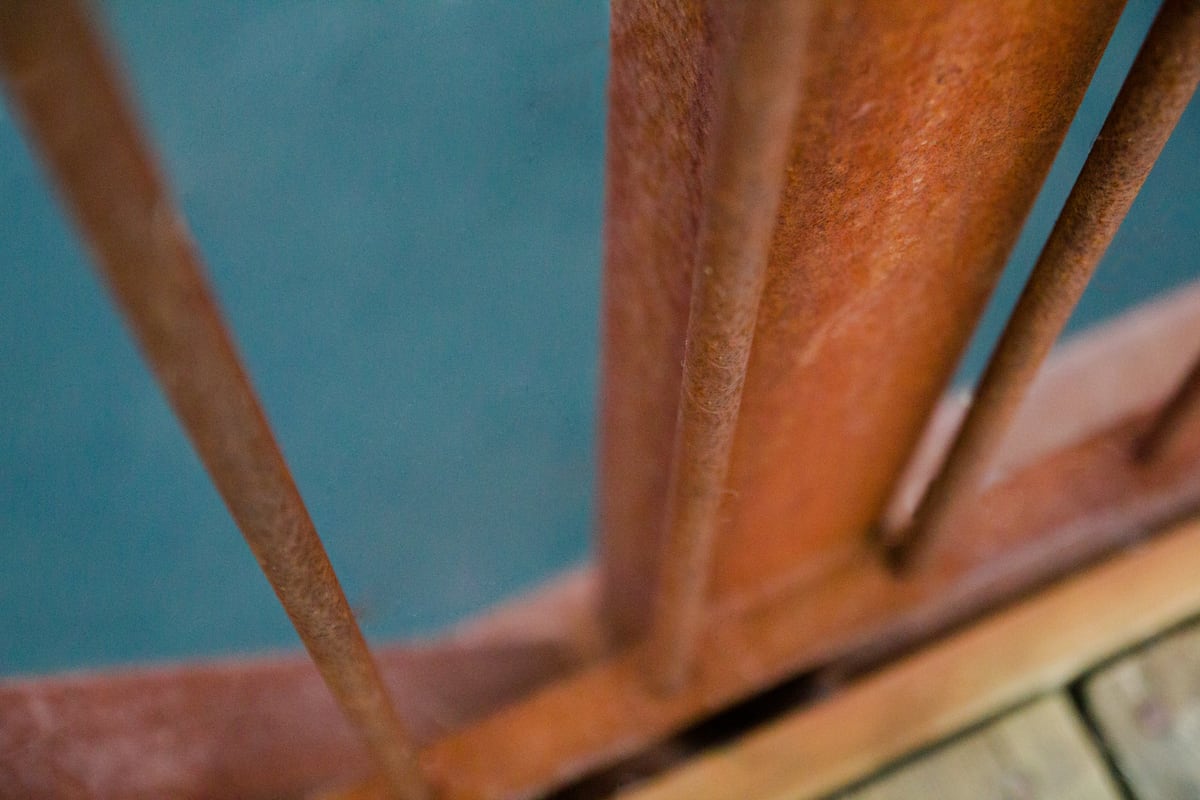 Warm wood, teal colour and railing lines form a close architectural detail in Peterborough, Ontario. print option