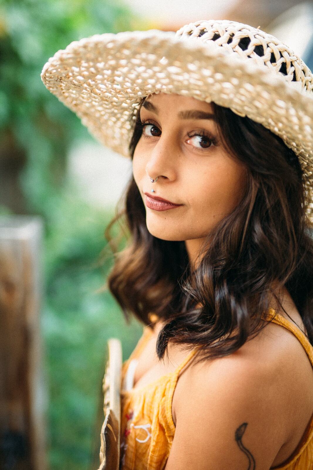 Angelica in Garden Light story frame 11: Mirror play, garden colour, straw hat and reflective frames with a quieter kind of romance.