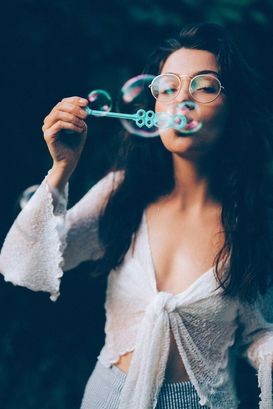 Mel in Reeds and Warm Dusk story frame 6: Bubbles, lake edge, reeds, glasses and dusk colour from a playful portrait story.