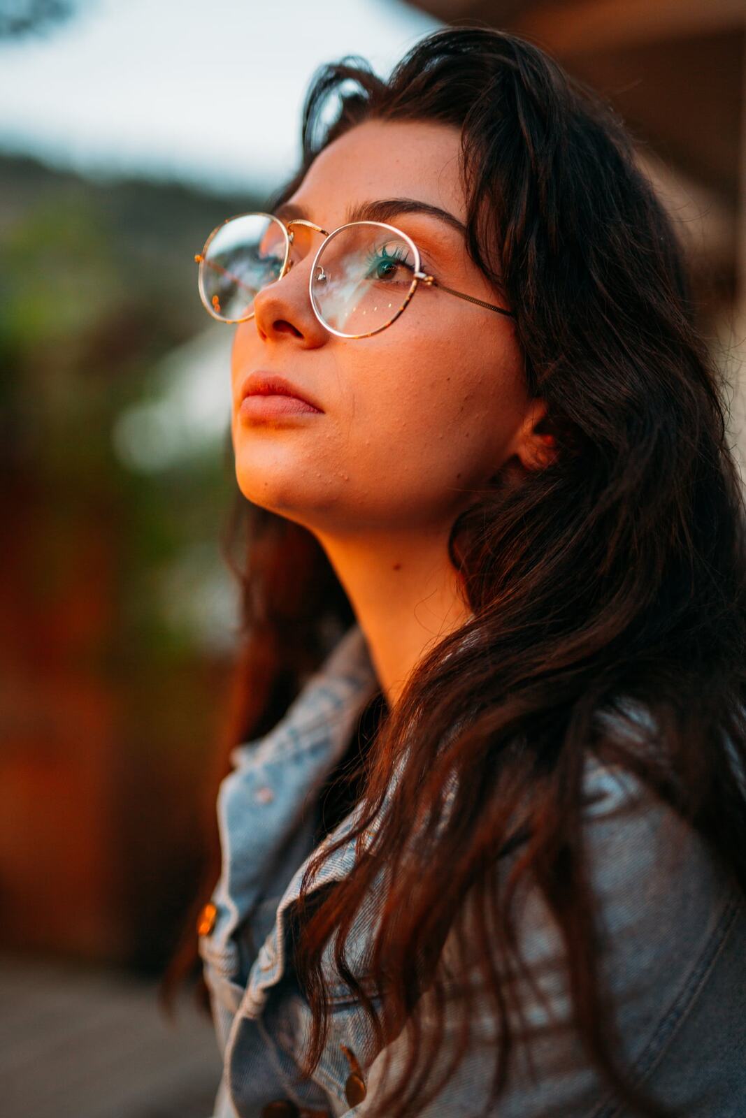 Mel in Reeds and Warm Dusk story frame 16: Bubbles, lake edge, reeds, glasses and dusk colour from a playful portrait story.
