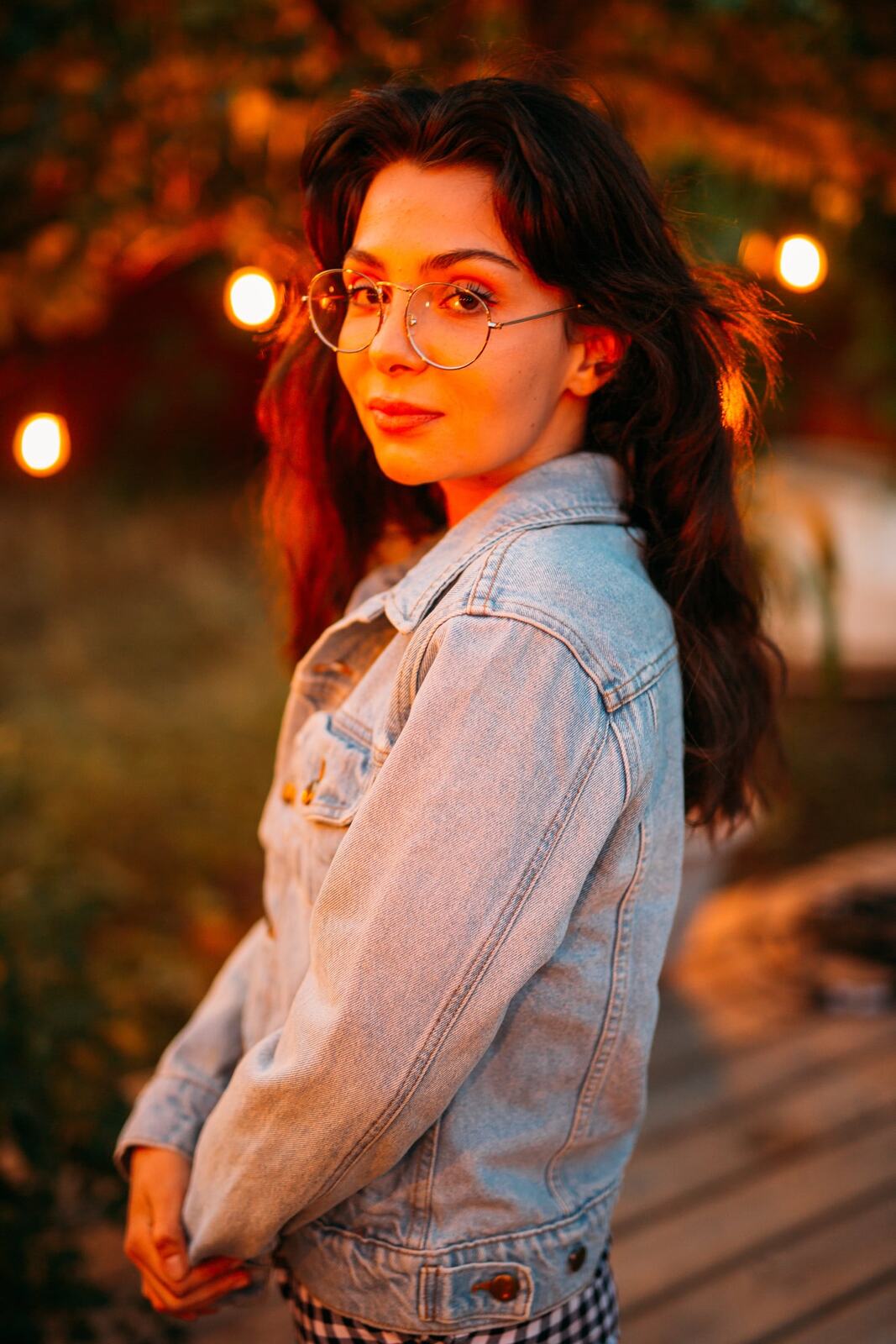 Mel in Reeds and Warm Dusk story frame 17: Bubbles, lake edge, reeds, glasses and dusk colour from a playful portrait story.