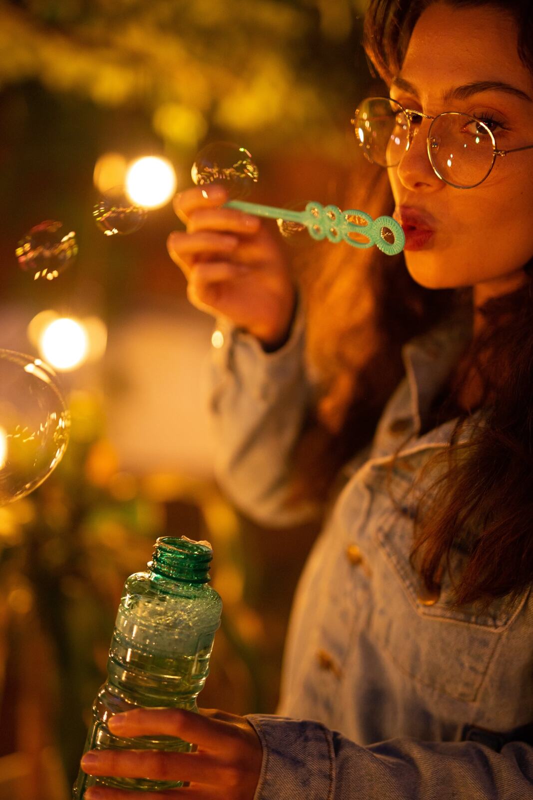 Mel in Reeds and Warm Dusk story frame 19: Bubbles, lake edge, reeds, glasses and dusk colour from a playful portrait story.