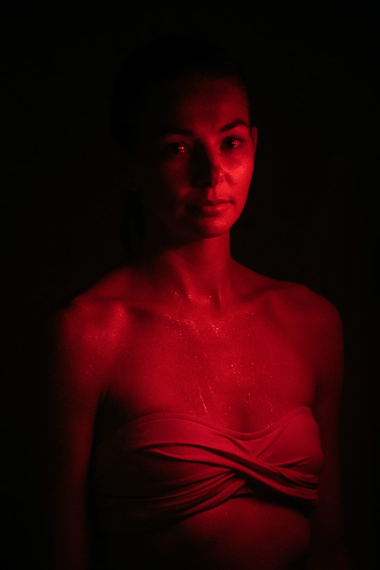 Angela at Float Space portraits story frame 4: A Float Space portrait set that moves from clean wellness headshots into red low-key portraits, skin, shadow and close detail.