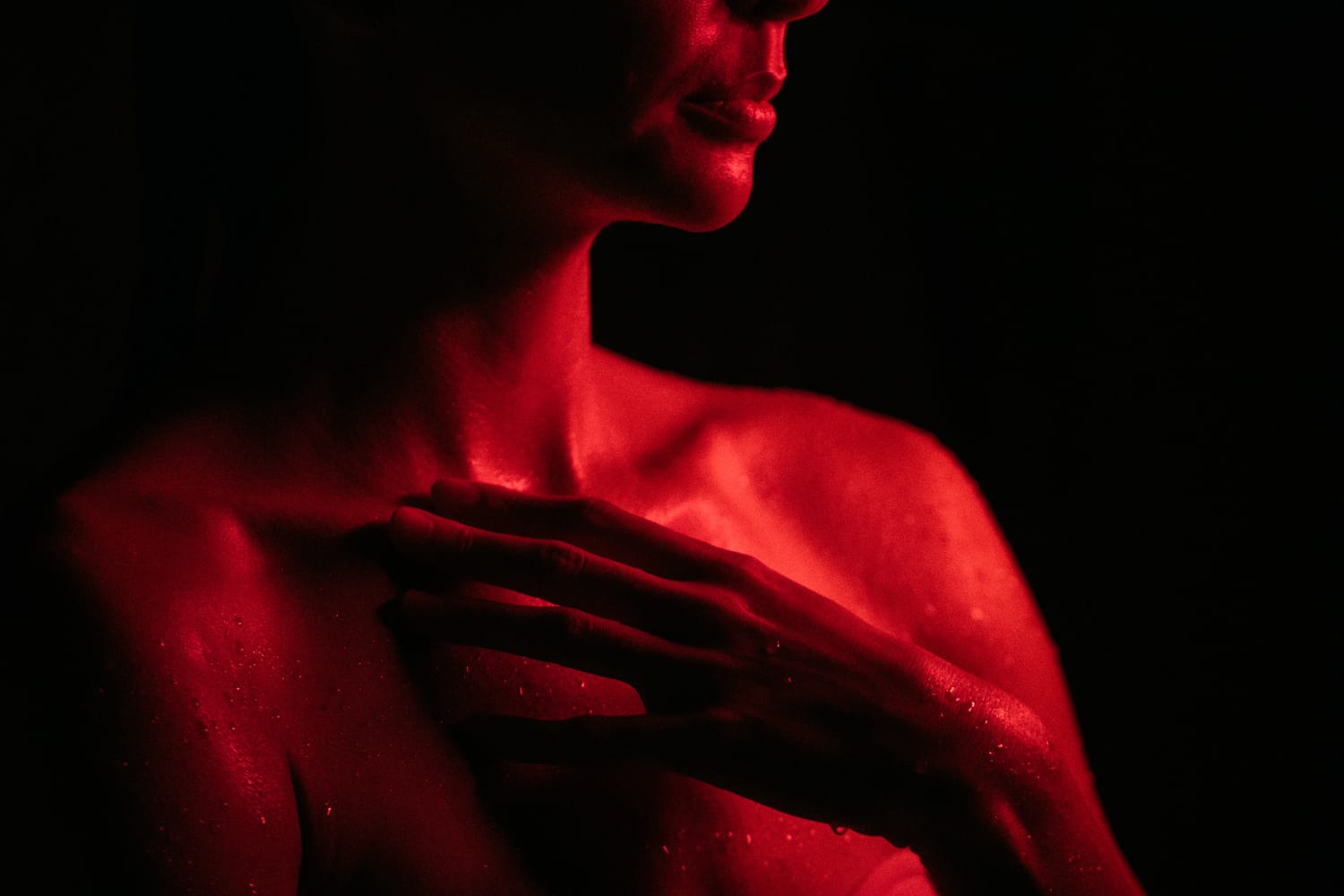 Angela at Float Space portraits story frame 8: A Float Space portrait set that moves from clean wellness headshots into red low-key portraits, skin, shadow and close detail.