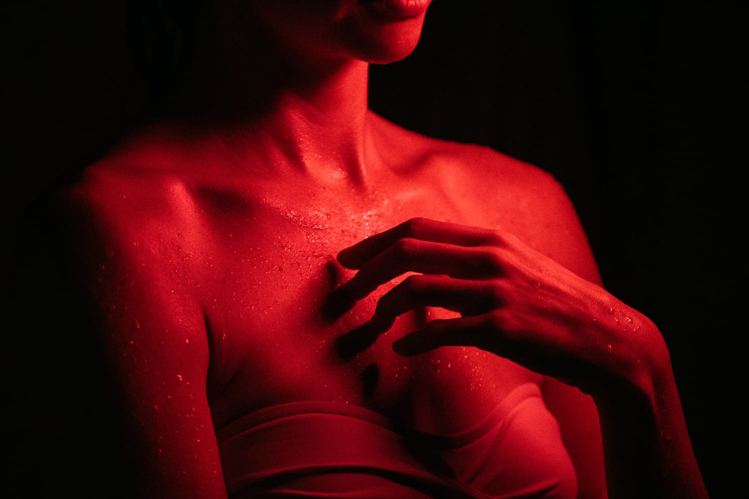 Angela at Float Space portraits story frame 9: A Float Space portrait set that moves from clean wellness headshots into red low-key portraits, skin, shadow and close detail.