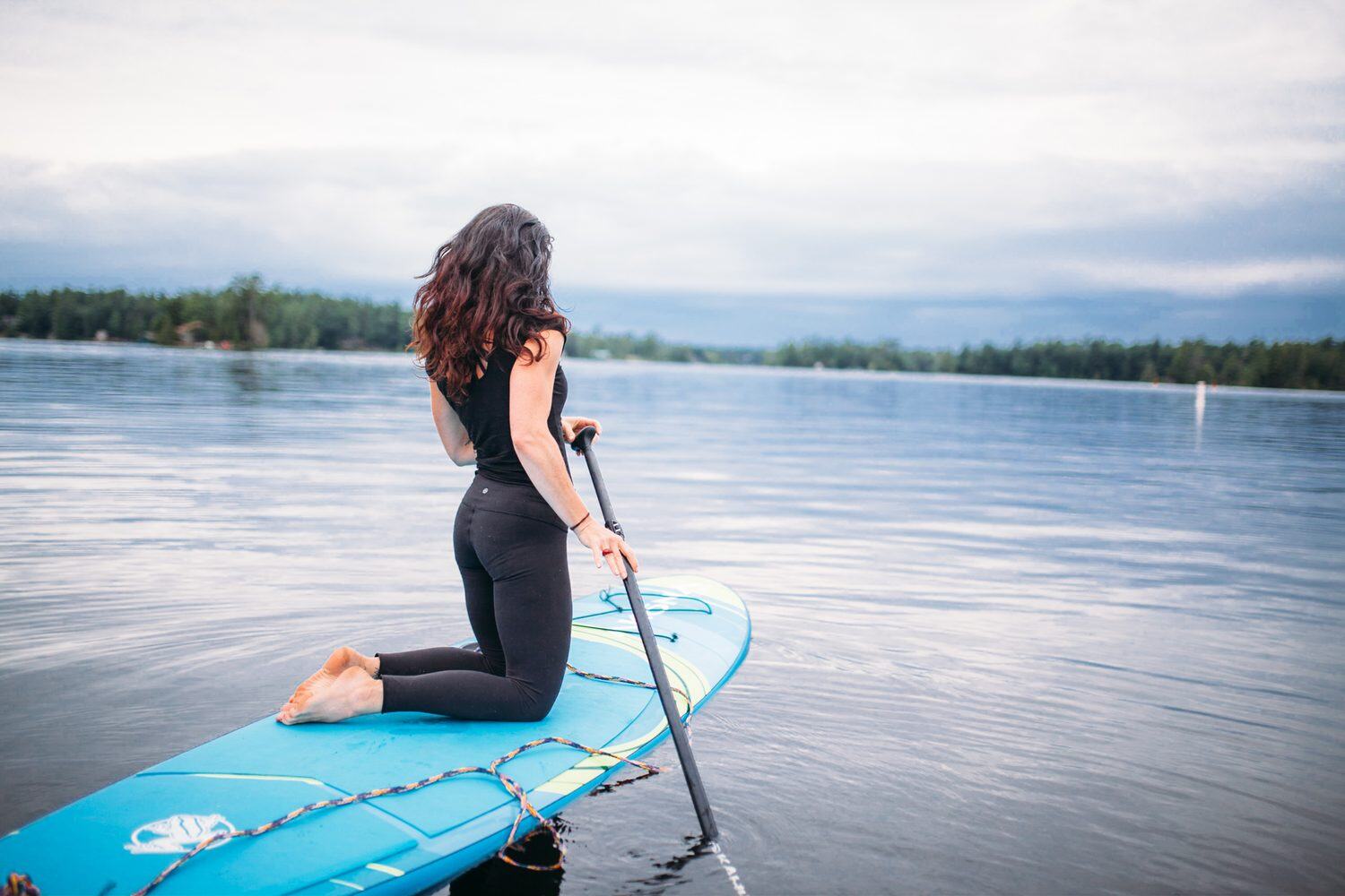 Ash and Jill, SUP Yoga corporate story frame 1: Corporate lifestyle photography for Ash and Jill on stand-up paddleboards, with yoga movement, instructor portraits and lake-based imagery for a wellness business.