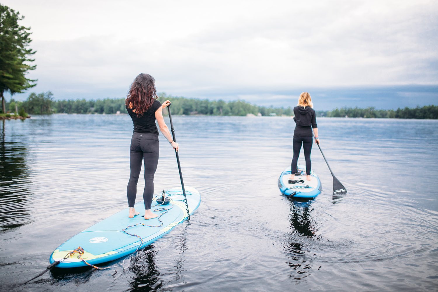 Ash and Jill, SUP Yoga corporate story frame 2: Corporate lifestyle photography for Ash and Jill on stand-up paddleboards, with yoga movement, instructor portraits and lake-based imagery for a wellness business.