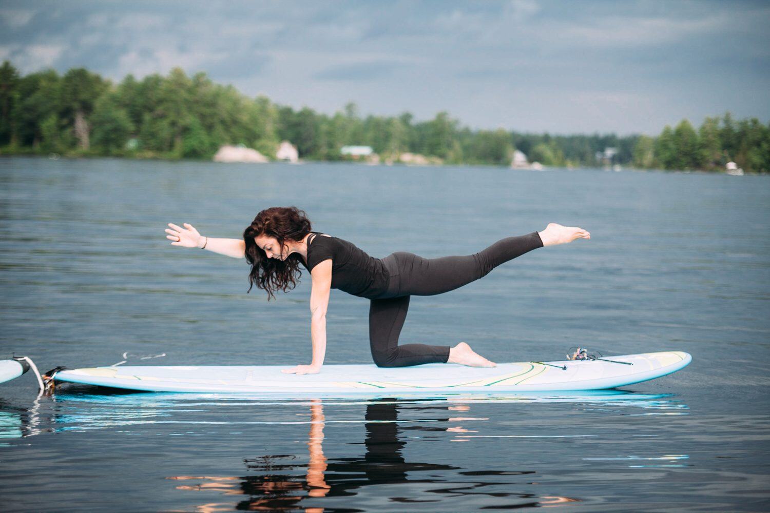 Ash and Jill, SUP Yoga corporate story frame 6: Corporate lifestyle photography for Ash and Jill on stand-up paddleboards, with yoga movement, instructor portraits and lake-based imagery for a wellness business.