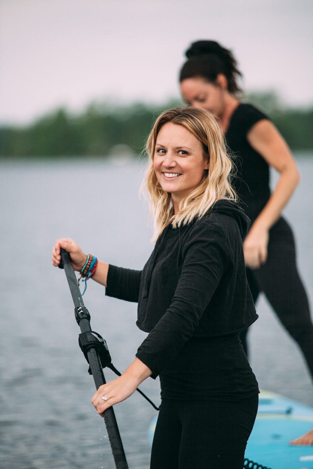 Ash and Jill, SUP Yoga corporate story frame 11: Corporate lifestyle photography for Ash and Jill on stand-up paddleboards, with yoga movement, instructor portraits and lake-based imagery for a wellness business.