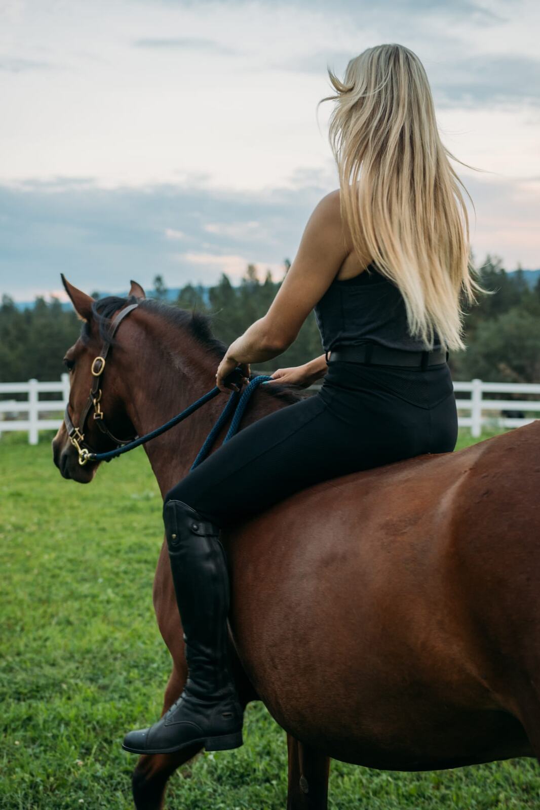 Ashton at the Ranch portraits story frame 7: Ranch portraits for Ashton in Kelowna, with horses, open pasture, quiet country styling and Okanagan light shaped into a grounded portrait story.