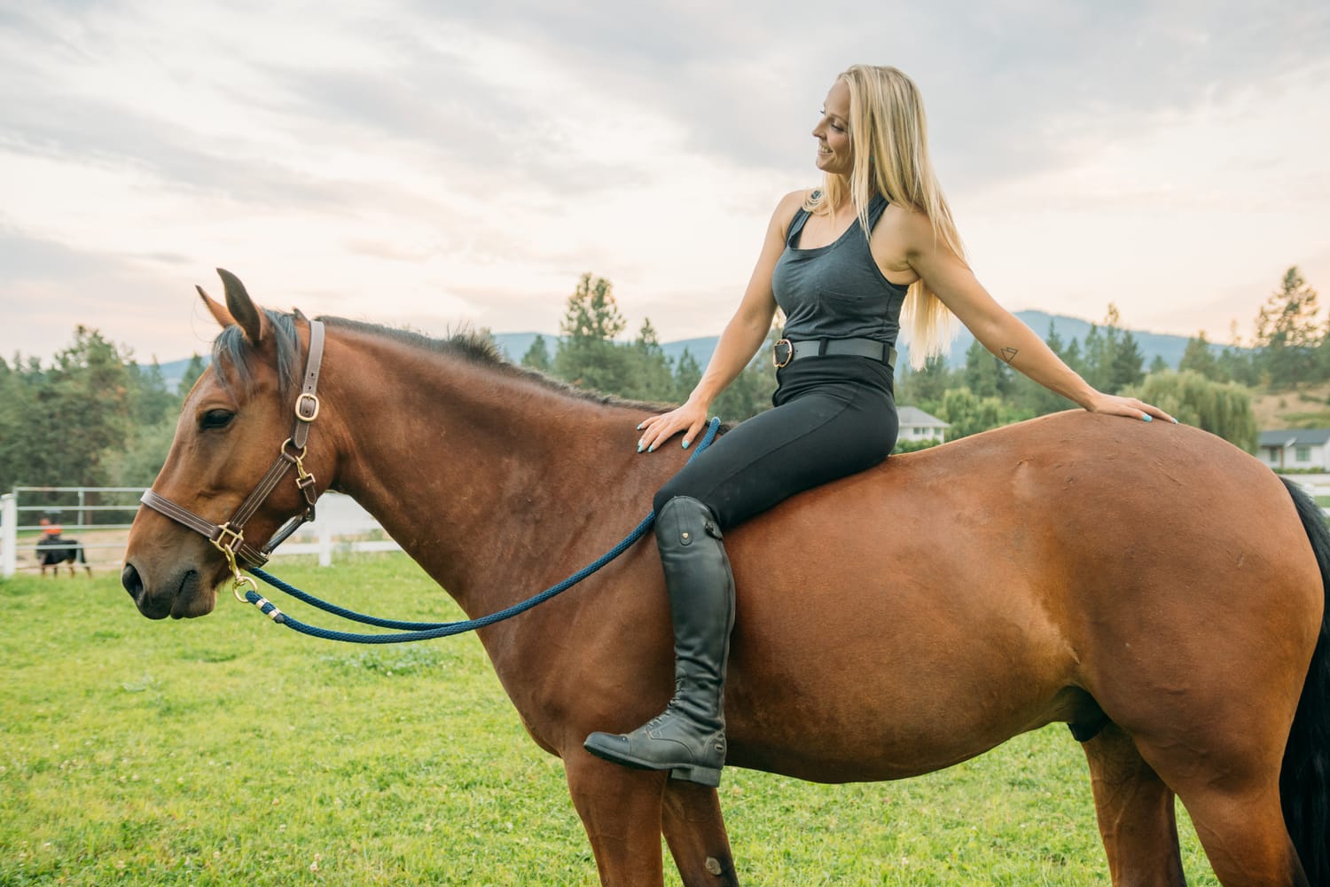 Ashton at the Ranch portraits story frame 8: Ranch portraits for Ashton in Kelowna, with horses, open pasture, quiet country styling and Okanagan light shaped into a grounded portrait story.