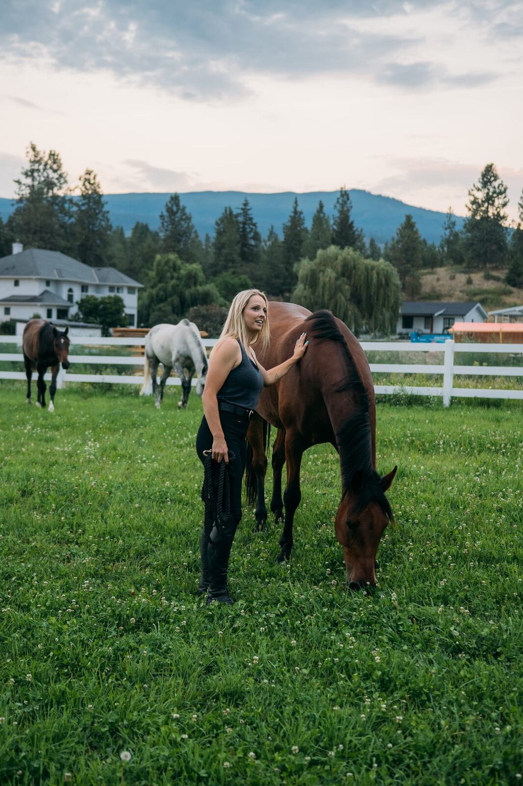 Ashton at the Ranch portraits story frame 17: Ranch portraits for Ashton in Kelowna, with horses, open pasture, quiet country styling and Okanagan light shaped into a grounded portrait story.