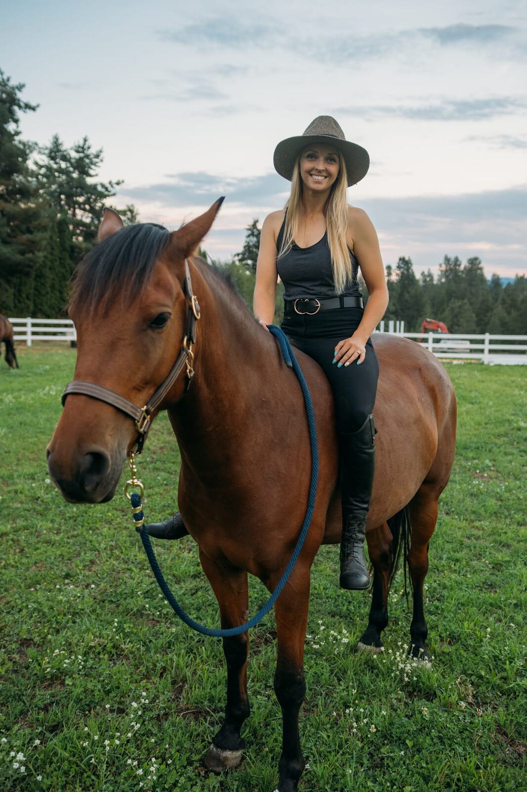 Ashton at the Ranch portraits story frame 4: Ranch portraits for Ashton in Kelowna, with horses, open pasture, quiet country styling and Okanagan light shaped into a grounded portrait story.