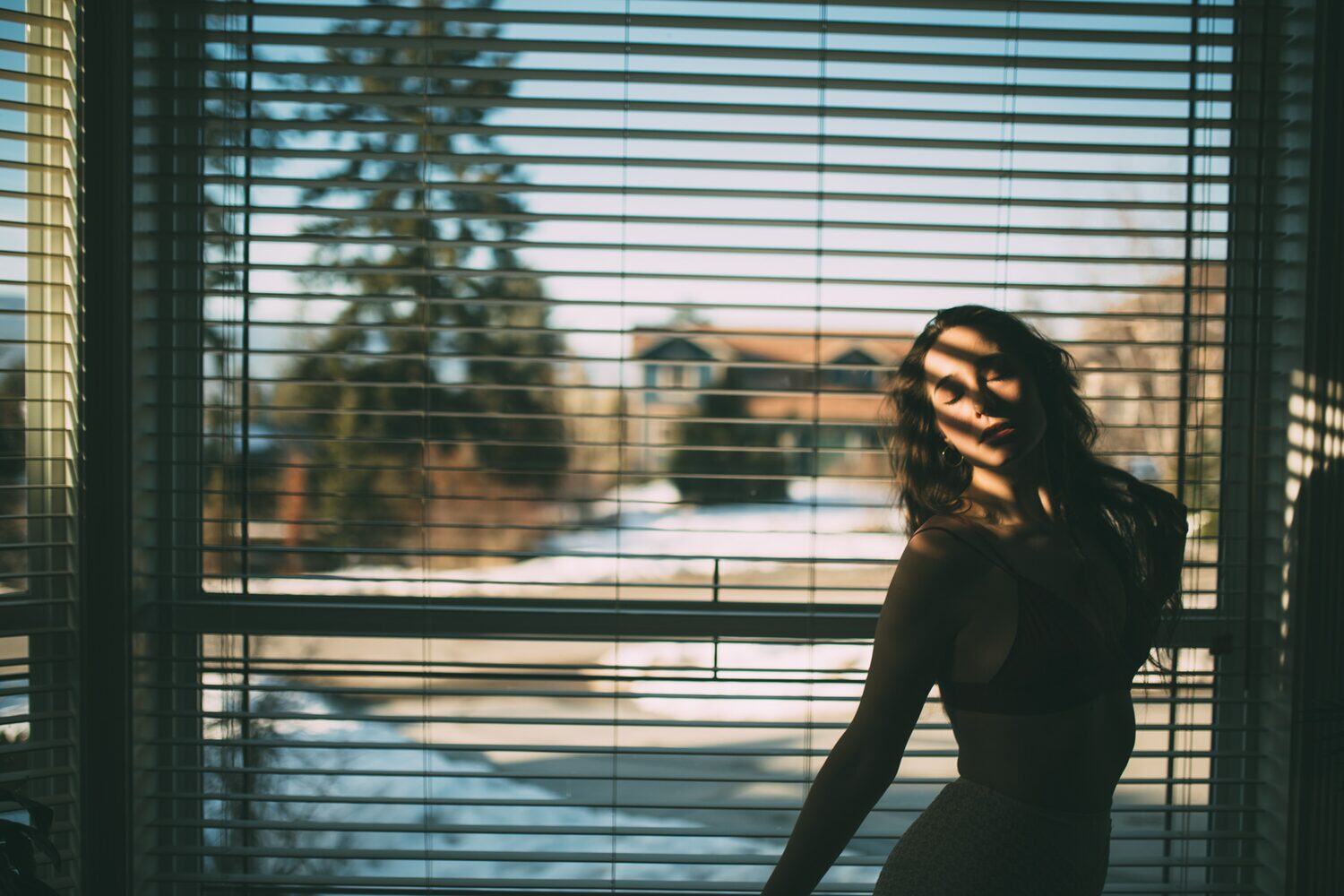 Bailey in Kelowna portraits story frame 6: Two portrait sessions moving through window light, body line, bold colour, foliage and floral-bath portraits.