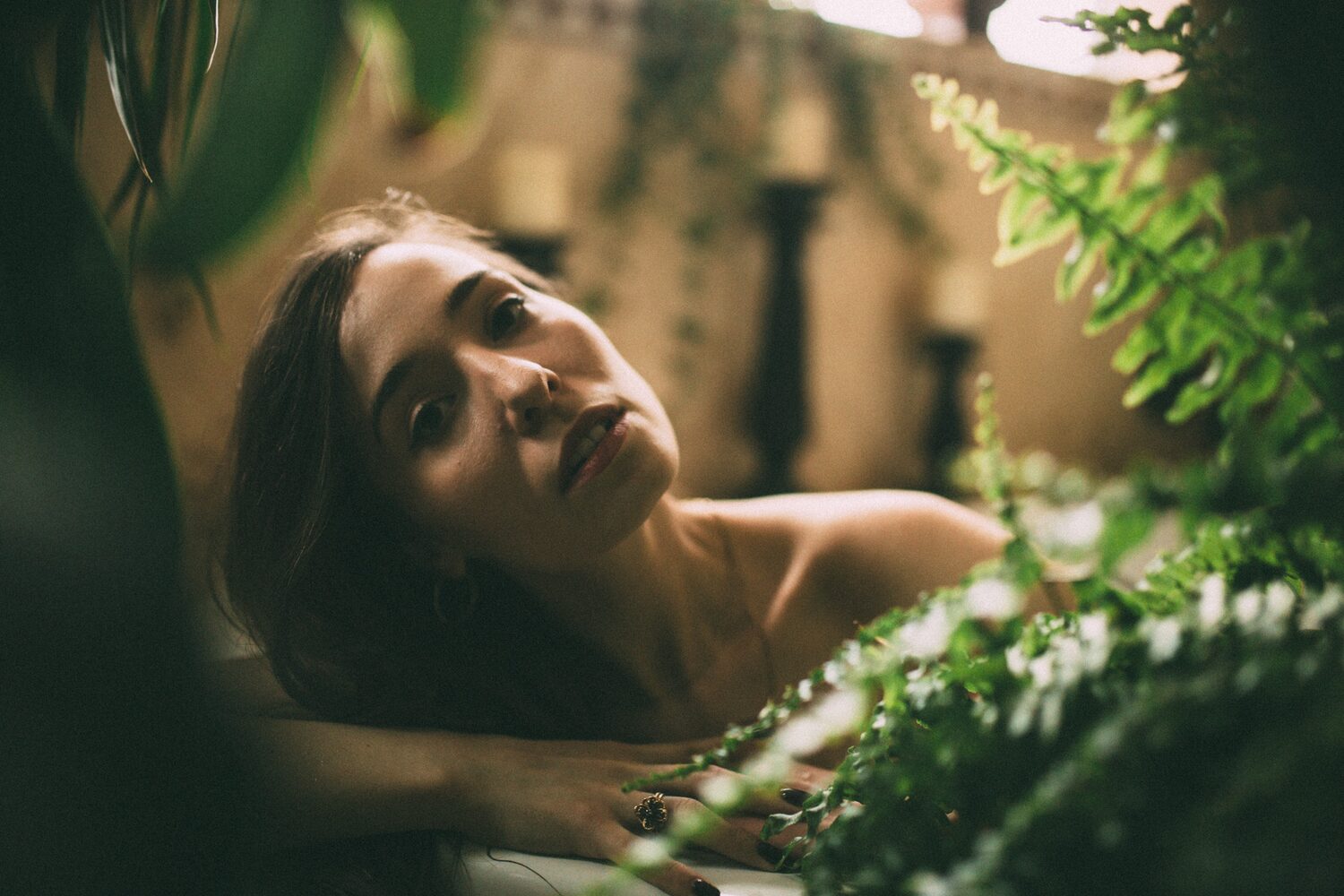Bailey in Kelowna portraits story frame 34: Two portrait sessions moving through window light, body line, bold colour, foliage and floral-bath portraits.
