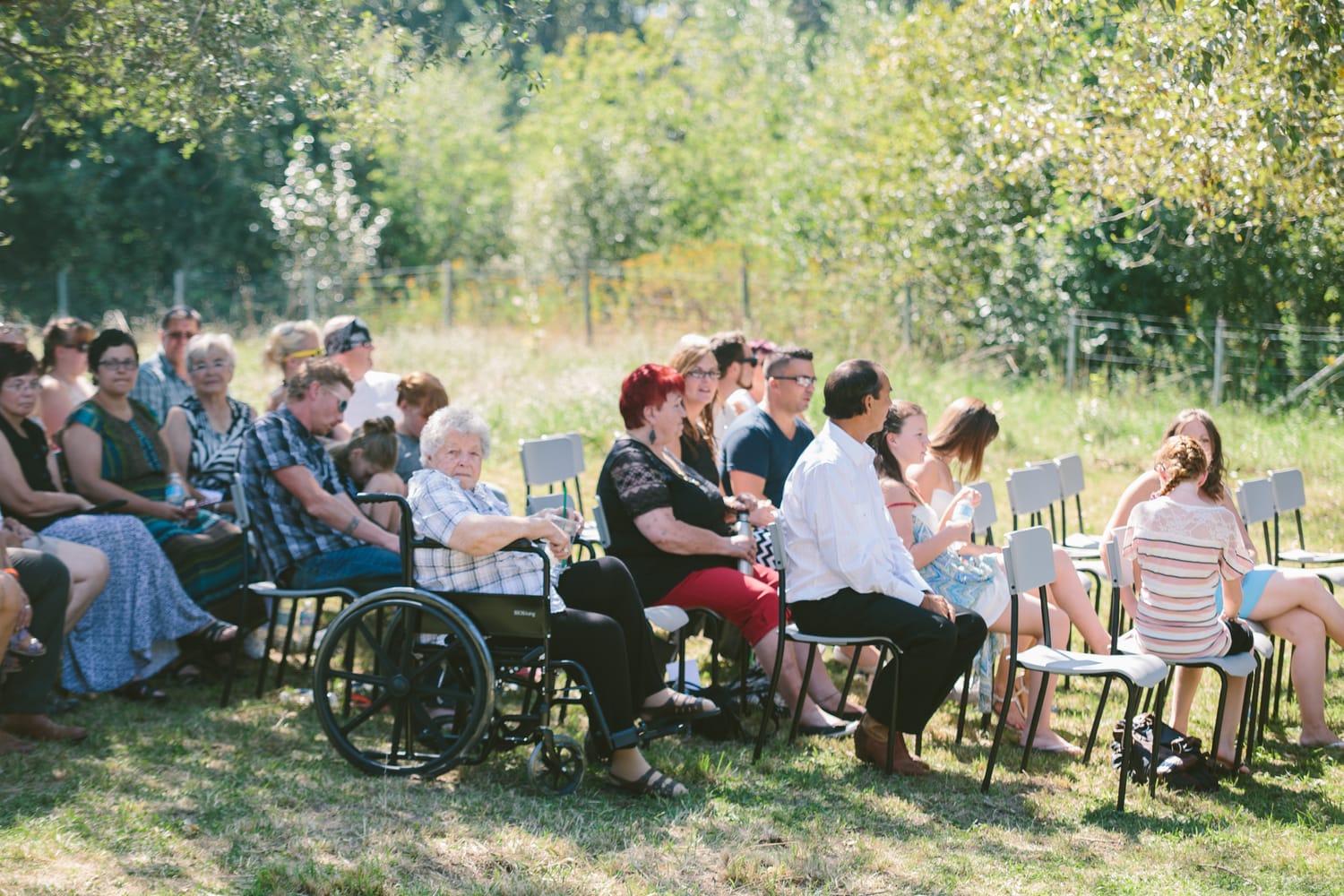Barbara and Ryan weddings story frame 7: A Salmon Arm wedding near Mount Ida, moving from a private yard to Marine Peace Park and wharf portraits, with the groom's trucking life part of the story..