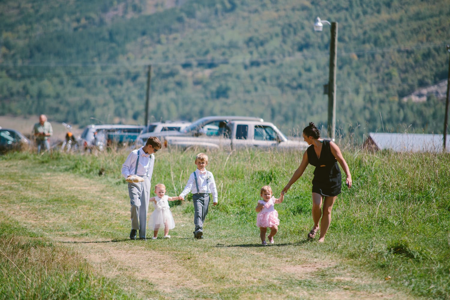 Barbara and Ryan weddings story frame 8: A Salmon Arm wedding near Mount Ida, moving from a private yard to Marine Peace Park and wharf portraits, with the groom's trucking life part of the story..