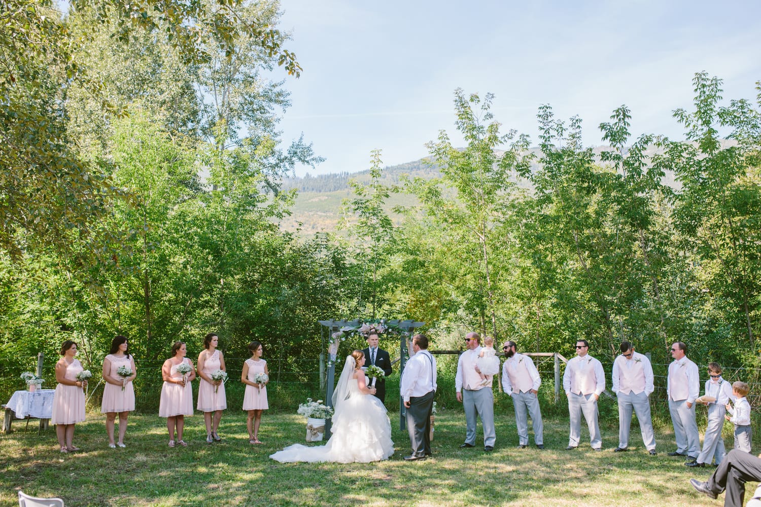 Barbara and Ryan weddings story frame 12: A Salmon Arm wedding near Mount Ida, moving from a private yard to Marine Peace Park and wharf portraits, with the groom's trucking life part of the story..