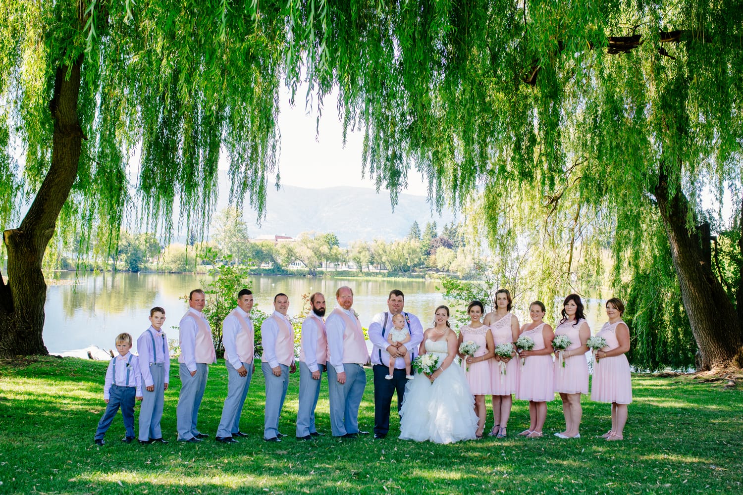 Barbara and Ryan weddings story frame 20: A Salmon Arm wedding near Mount Ida, moving from a private yard to Marine Peace Park and wharf portraits, with the groom's trucking life part of the story..