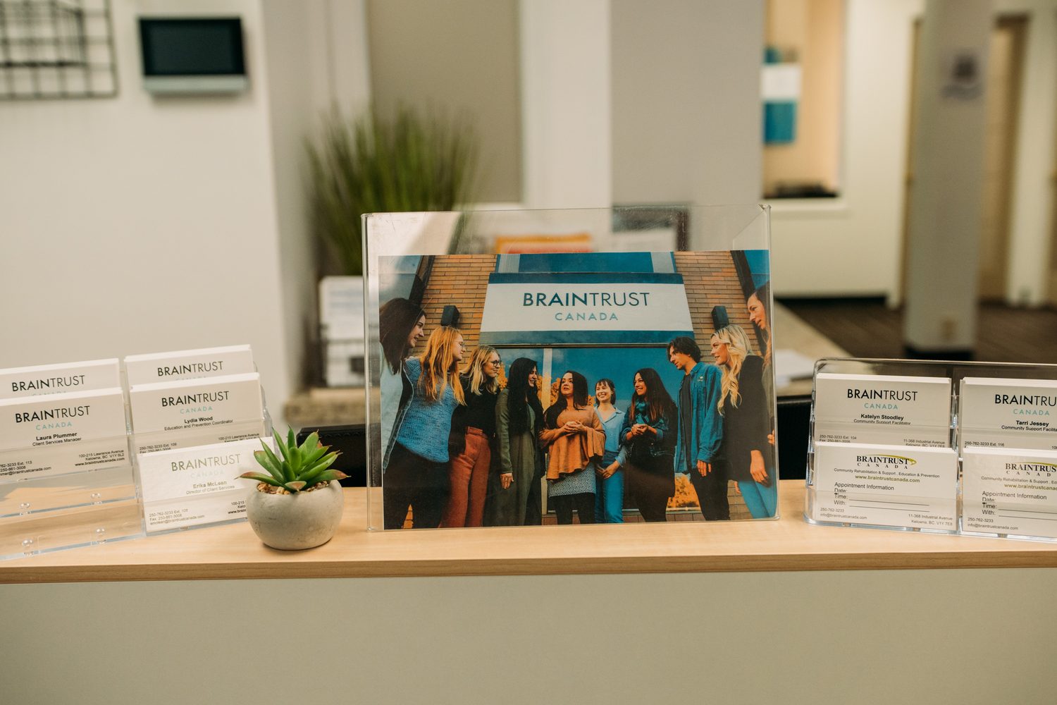BrainTrust Canada Grand Opening corporate story frame 2: Event photography for BrainTrust Canada's Kelowna grand opening, with ribbon cutting, guests, office details, local food and exterior images for community and nonprofit communications..