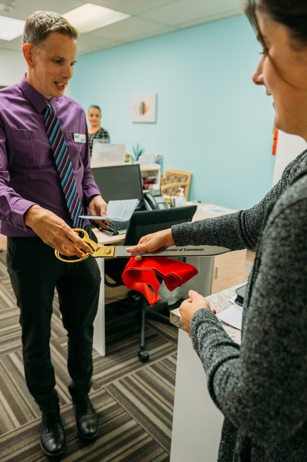 BrainTrust Canada Grand Opening corporate story frame 9: Event photography for BrainTrust Canada's Kelowna grand opening, with ribbon cutting, guests, office details, local food and exterior images for community and nonprofit communications..