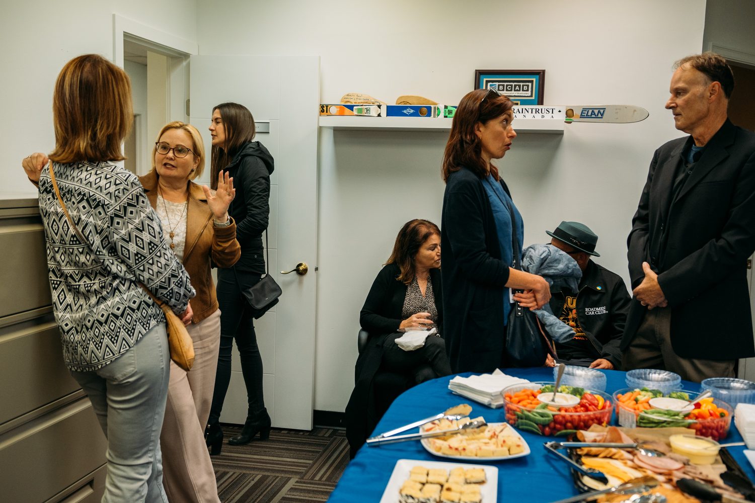 BrainTrust Canada Grand Opening corporate story frame 14: Event photography for BrainTrust Canada's Kelowna grand opening, with ribbon cutting, guests, office details, local food and exterior images for community and nonprofit communications..