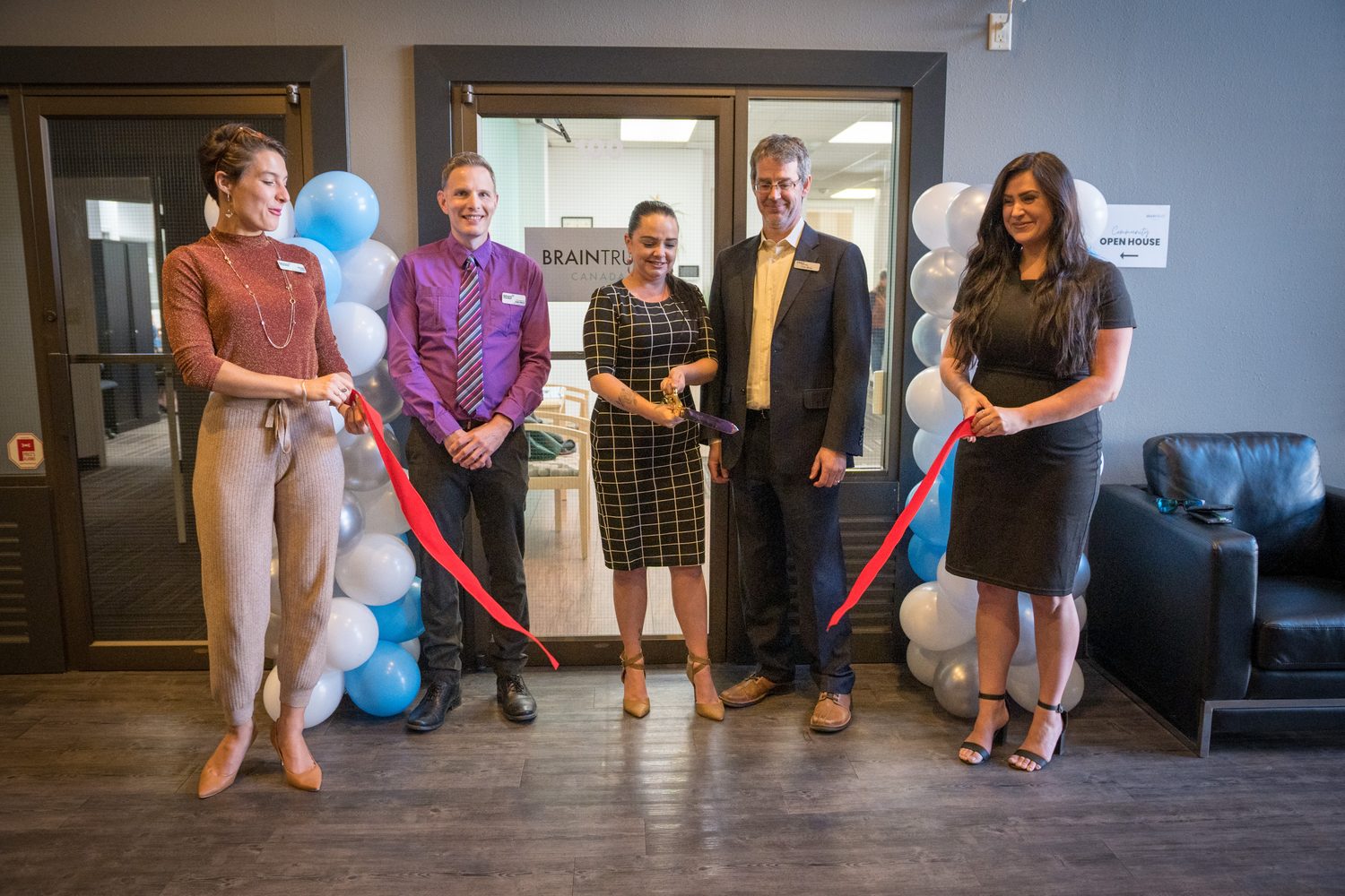 BrainTrust Canada Grand Opening corporate story frame 17: Event photography for BrainTrust Canada's Kelowna grand opening, with ribbon cutting, guests, office details, local food and exterior images for community and nonprofit communications..