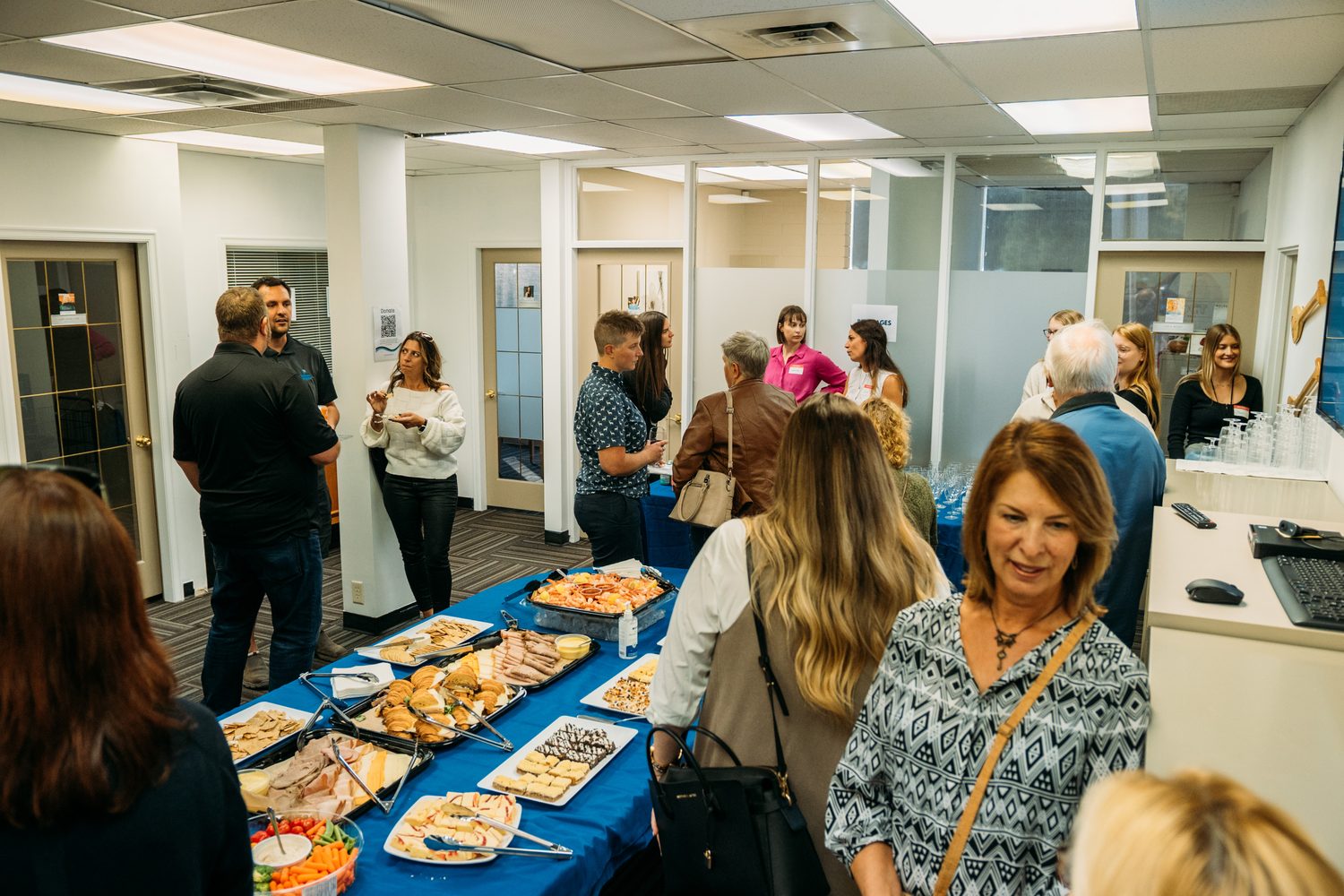 BrainTrust Canada Grand Opening corporate story frame 18: Event photography for BrainTrust Canada's Kelowna grand opening, with ribbon cutting, guests, office details, local food and exterior images for community and nonprofit communications..