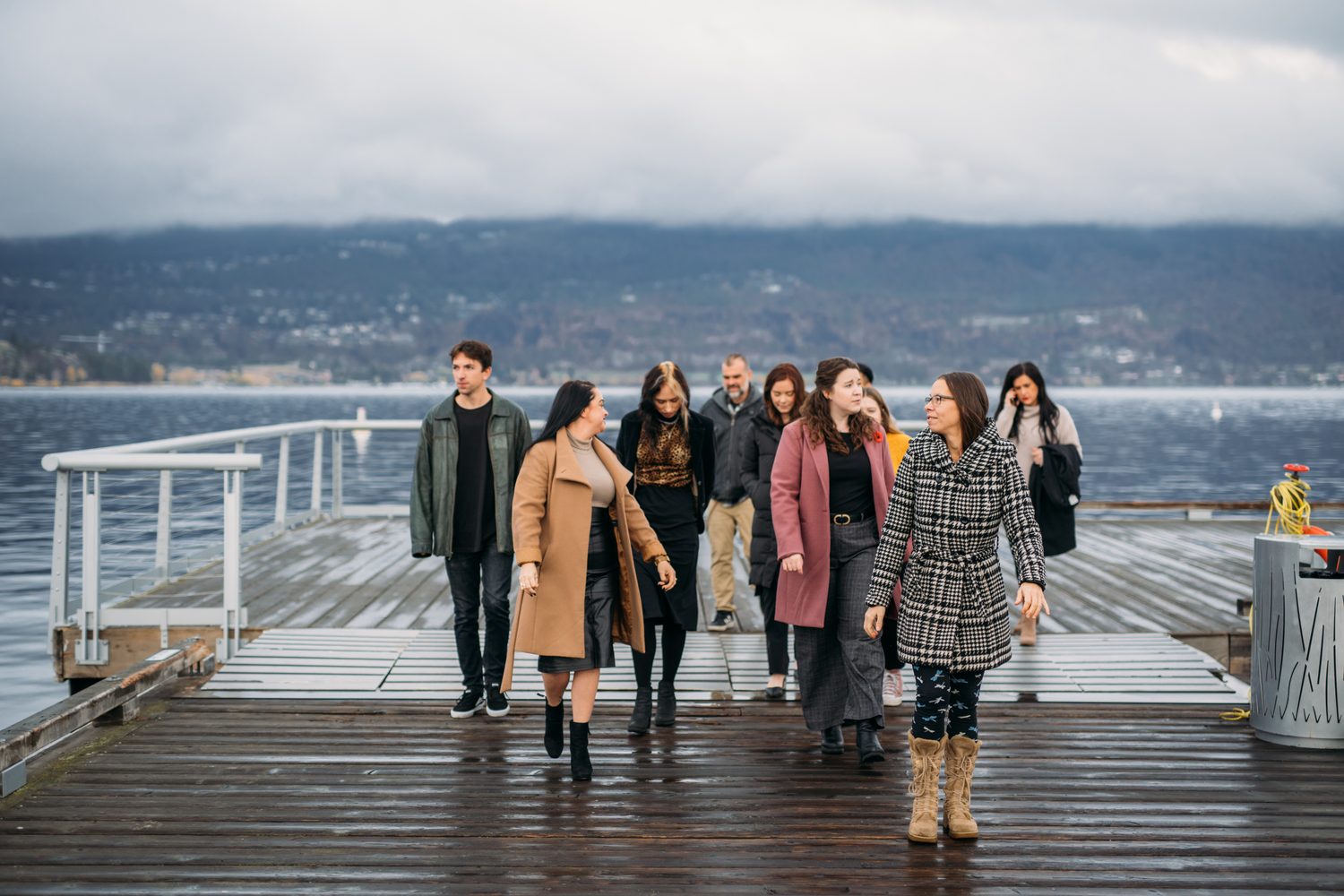 BrainTrust Canada Waterfront corporate story frame 16: Waterfront team and brand portraits for BrainTrust Canada in Kelowna, built around group photos, walking images and approachable nonprofit profile photography..
