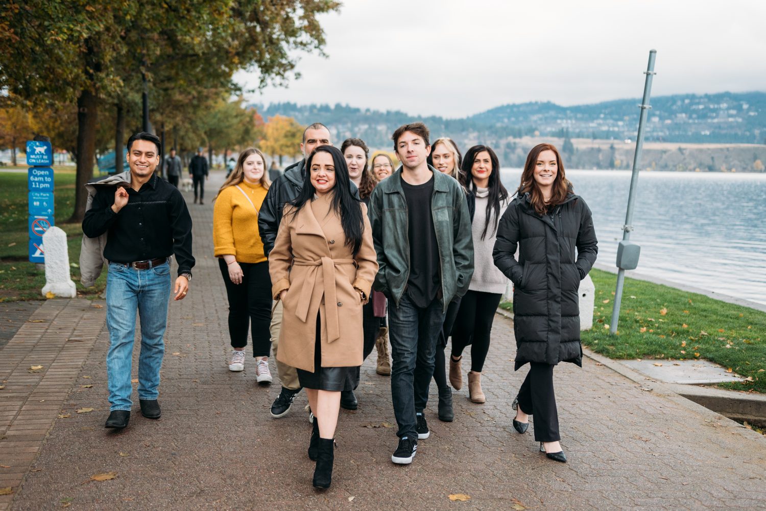BrainTrust Canada Waterfront corporate story frame 28: Waterfront team and brand portraits for BrainTrust Canada in Kelowna, built around group photos, walking images and approachable nonprofit profile photography..