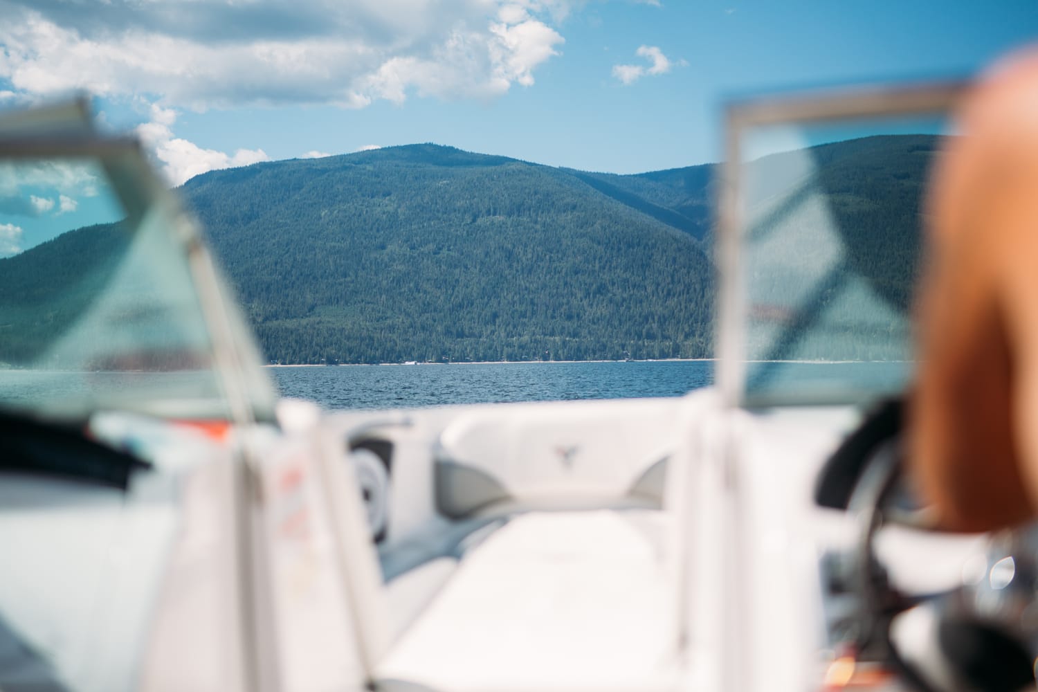 Carmel and Chris weddings story frame 2: A Sicamous and Shuswap Lake houseboat wedding that moved from water to beach, with friend-community overlap and a relaxed lakeside feeling..