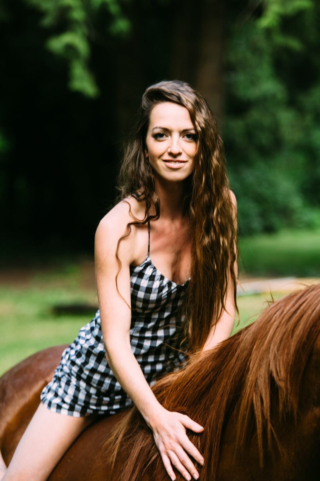 Charlotte, Rock the Dress portraits story frame 31: Charlotte Smith photographed for Rock the Dress near Salmon Arm, moving from blossoms and a yellow dress into creek, forest and horse portraits for the Canadian Cancer Society fundraiser.