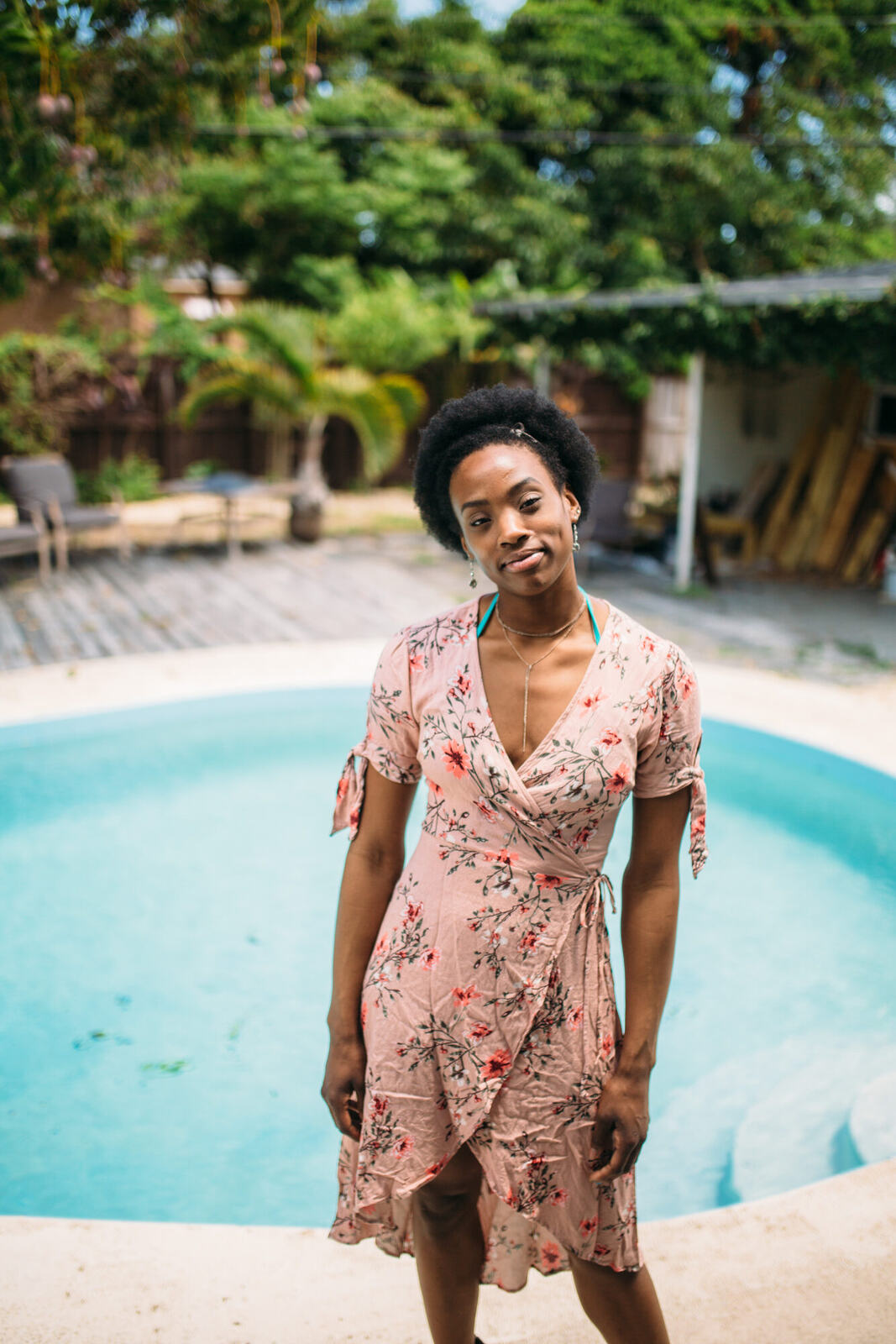 Dee-J in Miami portraits story frame 1: Two days with Dee-J in Miami, moving from a bright poolside portrait story to a second pool sequence and green-dress portraits along the riverbank.