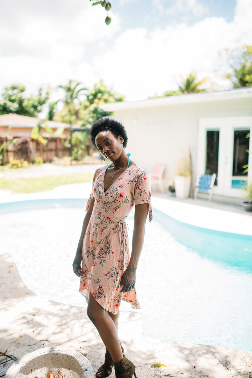 Dee-J in Miami portraits story frame 5: Two days with Dee-J in Miami, moving from a bright poolside portrait story to a second pool sequence and green-dress portraits along the riverbank.