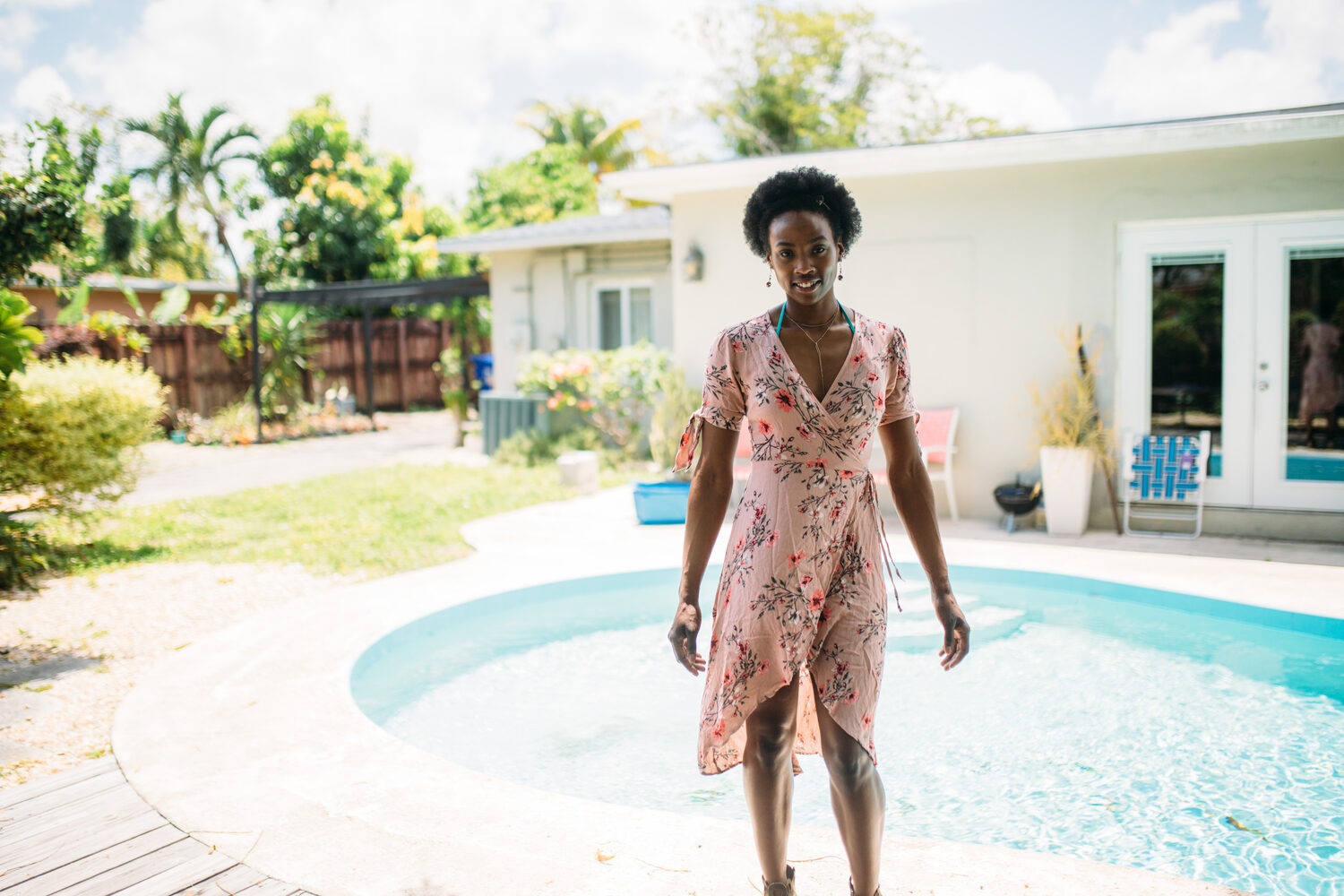 Dee-J in Miami portraits story frame 7: Two days with Dee-J in Miami, moving from a bright poolside portrait story to a second pool sequence and green-dress portraits along the riverbank.