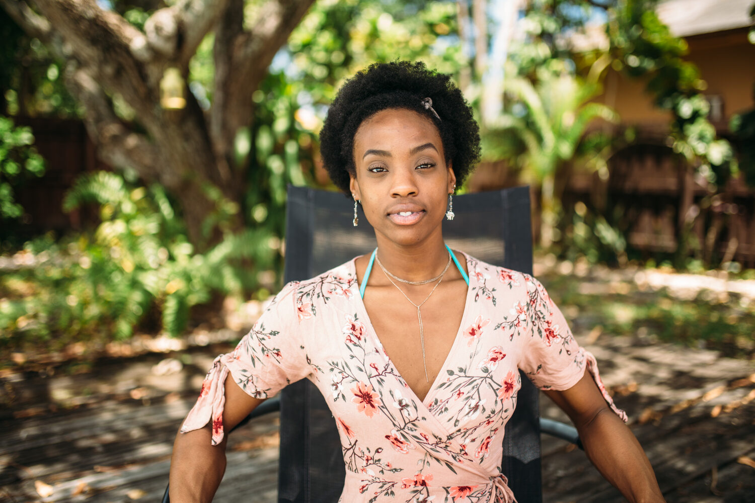 Dee-J in Miami portraits story frame 20: Two days with Dee-J in Miami, moving from a bright poolside portrait story to a second pool sequence and green-dress portraits along the riverbank.