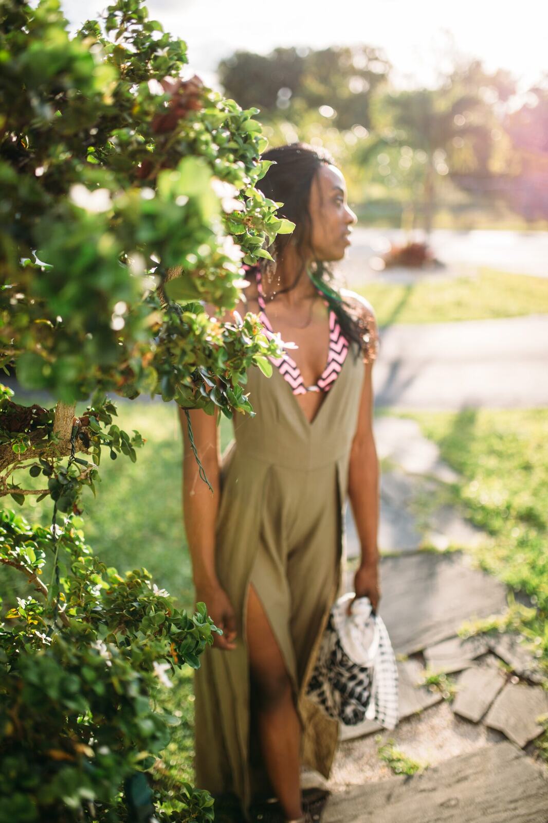 Dee-J in Miami portraits story frame 29: Two days with Dee-J in Miami, moving from a bright poolside portrait story to a second pool sequence and green-dress portraits along the riverbank.