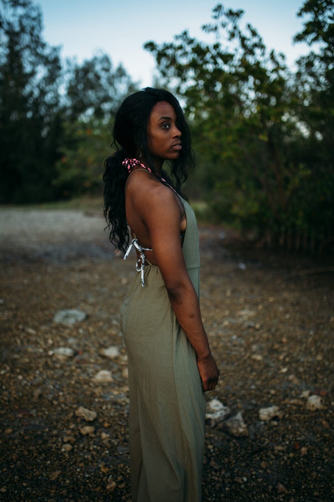 Dee-J in Miami portraits story frame 31: Two days with Dee-J in Miami, moving from a bright poolside portrait story to a second pool sequence and green-dress portraits along the riverbank.
