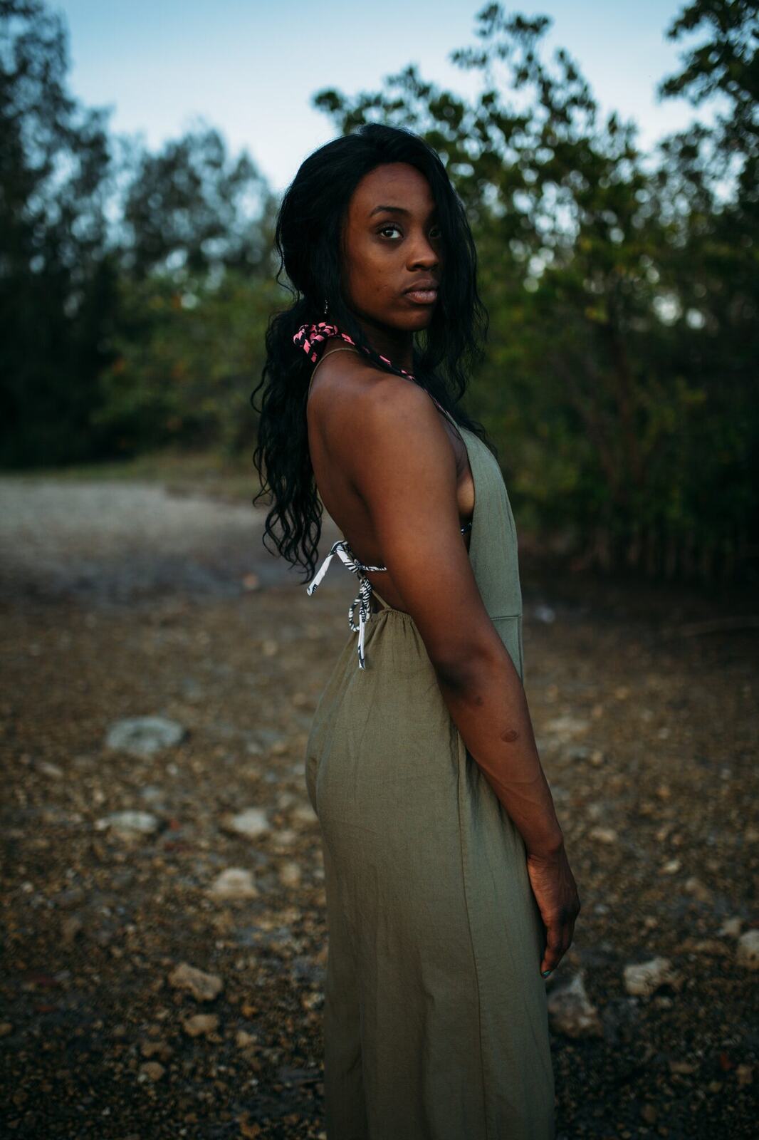 Dee-J in Miami portraits story frame 33: Two days with Dee-J in Miami, moving from a bright poolside portrait story to a second pool sequence and green-dress portraits along the riverbank.