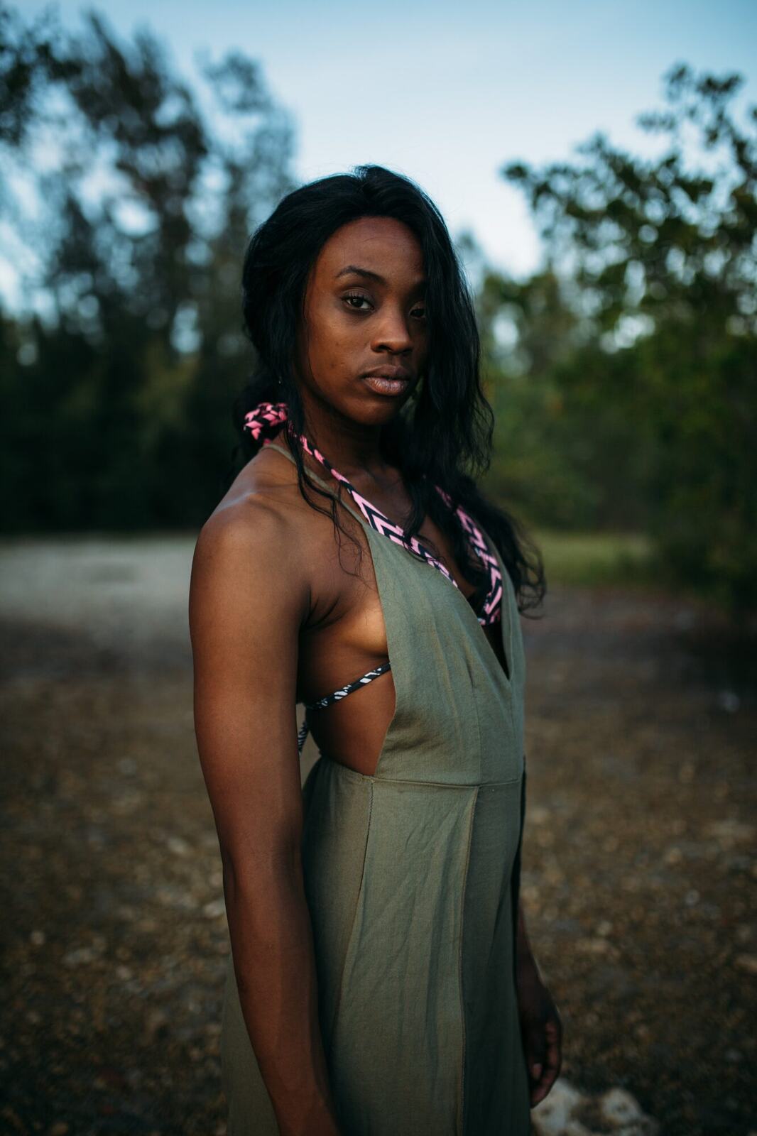 Dee-J in Miami portraits story frame 34: Two days with Dee-J in Miami, moving from a bright poolside portrait story to a second pool sequence and green-dress portraits along the riverbank.
