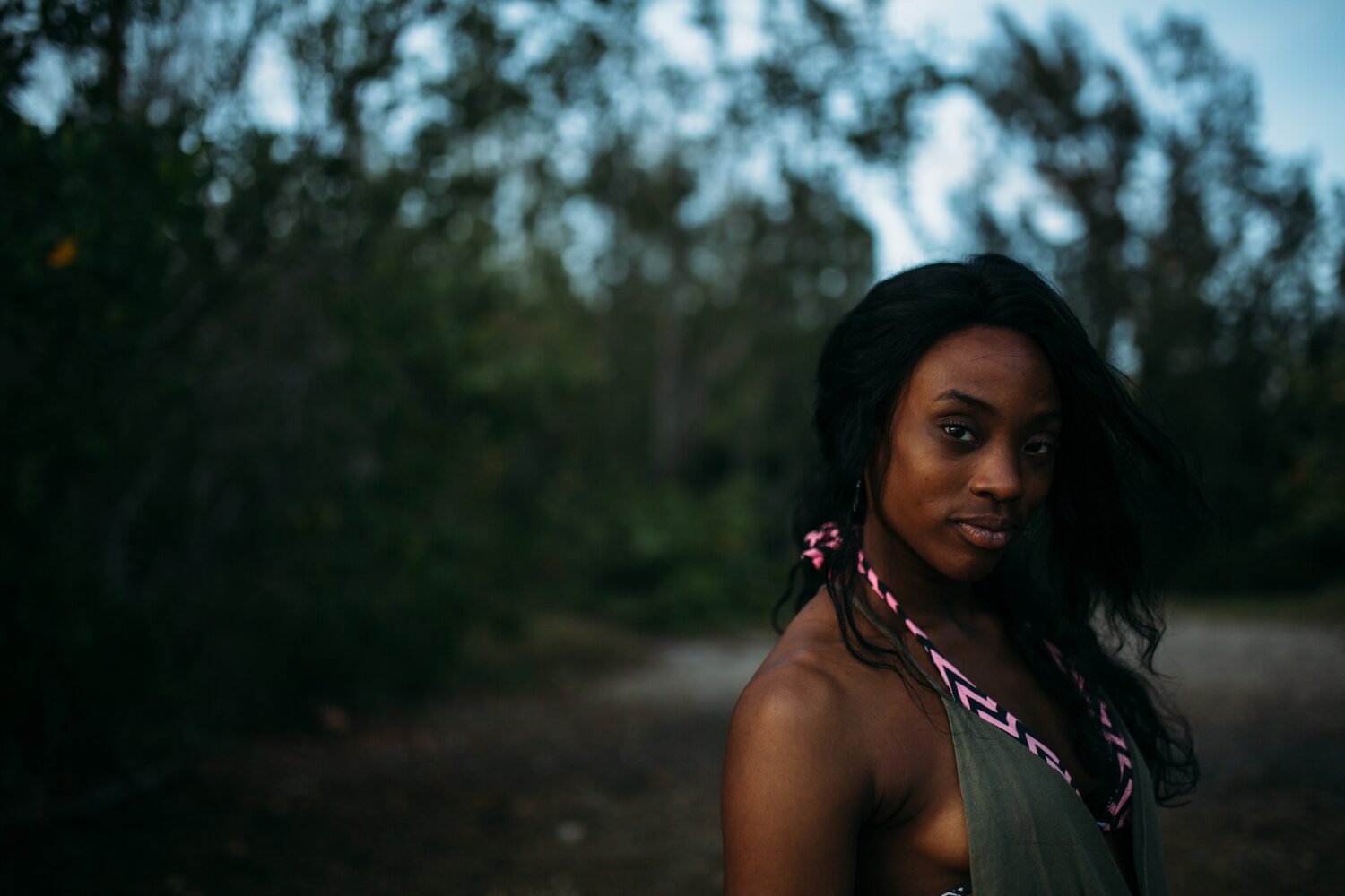 Dee-J in Miami portraits story frame 35: Two days with Dee-J in Miami, moving from a bright poolside portrait story to a second pool sequence and green-dress portraits along the riverbank.