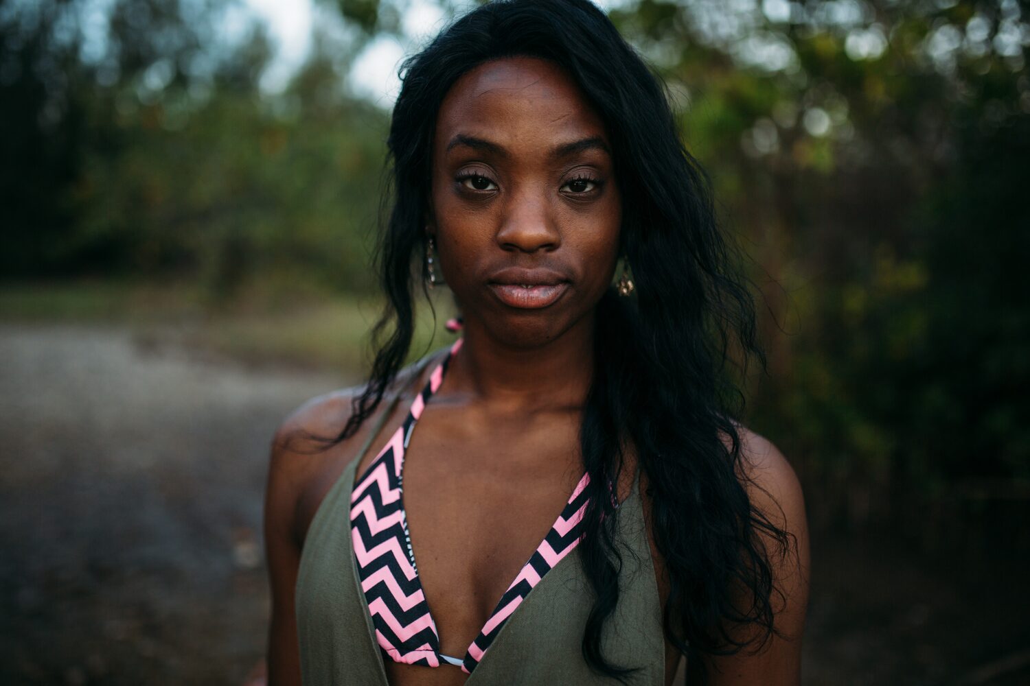 Dee-J in Miami portraits story frame 37: Two days with Dee-J in Miami, moving from a bright poolside portrait story to a second pool sequence and green-dress portraits along the riverbank.