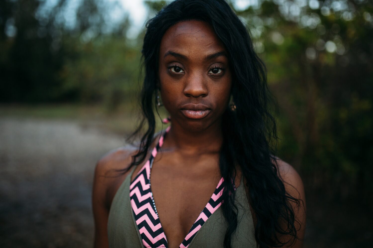 Dee-J in Miami portraits story frame 38: Two days with Dee-J in Miami, moving from a bright poolside portrait story to a second pool sequence and green-dress portraits along the riverbank.