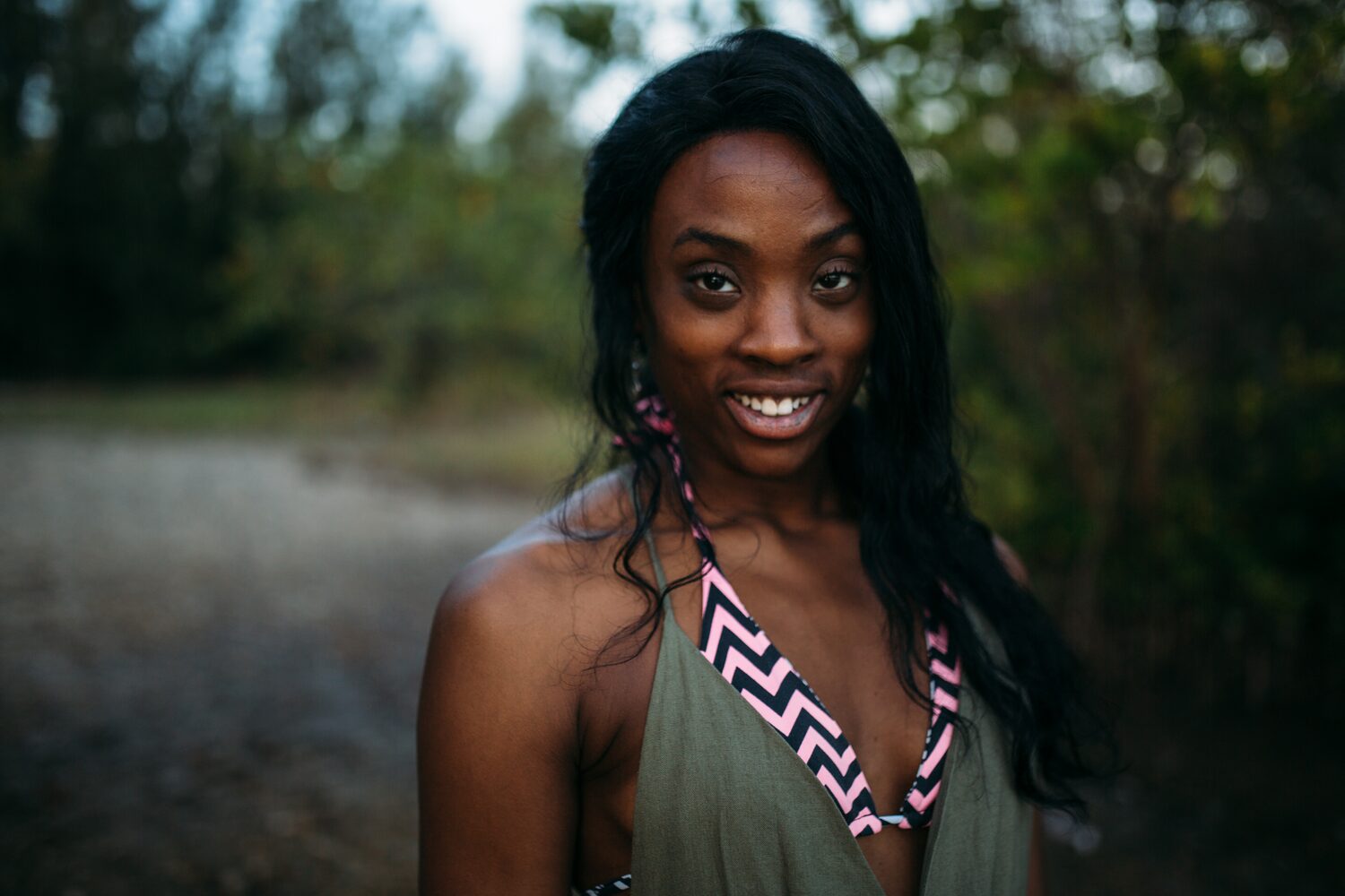 Dee-J in Miami portraits story frame 39: Two days with Dee-J in Miami, moving from a bright poolside portrait story to a second pool sequence and green-dress portraits along the riverbank.