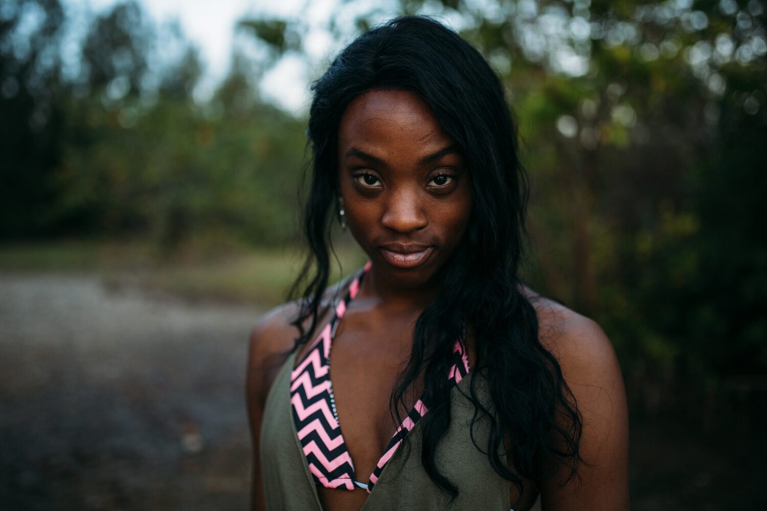 Dee-J in Miami portraits story frame 40: Two days with Dee-J in Miami, moving from a bright poolside portrait story to a second pool sequence and green-dress portraits along the riverbank.
